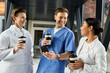 © LIGHTFIELD STUDIOS - Joyful collaboration among diverse medical professionals in a modern hospital