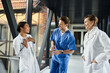 © LIGHTFIELD STUDIOS - Three multicultural doctors collaborating in a modern hospital environment