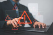 © Nirusmee - Ransomware malware attack and data breach. Businessperson using laptop with spam virus on warning caution for notification on internet security protect.