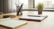 © Igor - Modern workspace with notebook, plant, and stationery on wooden desk