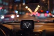© juliars - Gps device displaying wifi signal mounted on car dashboard with blurred city lights in background at night
