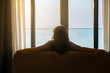 © shine - Simple lifestyle take it easy relaxation of Businesswoman looking outside hotel window Inspirational ocean beach sunset view, enjoying her summer vacation in luxury hotel. Twilight sky, Copy space