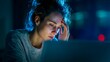 © irawan - Woman experiencing mental fatigue while working on a device late at night