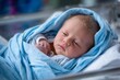 © Gatherina - Newborn baby wrapped in blue blanket sleeping peacefully