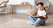 © Pixel-Shot - Little girl with headphones reading book at home