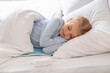 © Pixel-Shot - Cute little girl sleeping on electric heating pad in bedroom