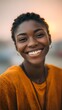 © Vital Stock - Joyful young woman with beautiful smile in warm sunset glow
