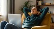 © MdNazim - Woman relaxing in armchair with laptop comfortable
