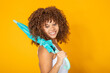 © carballo - beautiful young woman with umbrella isolated on yellow background