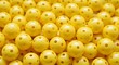 © sakib - Yellow pickleball balls piled together forming a bright background texture for sports and leisure activities