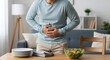 © Wool World - Man experiencing significant abdominal pain and discomfort after a healthy meal, possibly indicating digestive issues or a food sensitivity in a domestic setting