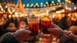 © Артур Комис - Mulled Wine Toast at a Christmas Market with Festive Bokeh