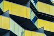 © yaqui_villegas - Yellow glass balcony architecture with strong geometric facade composition emphasizing minimal design and modern urban building structure captured in clean daylight perspective.