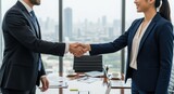 Business people shaking hands in a modern office. Man and woman partners making a deal. Concept of successful negotiation, agreement, partnership, and corporate collaboration.