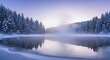 © CahyaSeptia - Serene Snowy Forest Lake Scene in Cold Winter Morning with Misty Fog and Reflective Water