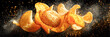 © Kowit - A dynamic image of flying potato chips surrounded by a sprinkle of seasoning, highlighting their crisp texture and golden color.