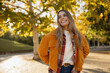 © mary_markevich - young beautiful blond woman walking in autumn park, stylish , smiling, happy, trendy season warm outfit, wearing velvet terracotta color jacket
