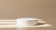 © Arifkki - Minimalist round marble podium on beige background with soft lighting, perfect for product display or cosmetic presentation.
