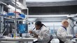 © DC Studio - Black female researcher studies molecular biology samples in a lab, using professional microscope. Healthcare innovation and biochemistry experiments represent scientific method.