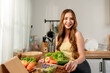 © Kawee - Portrait of Asian young woman cooking healthy foods in kitchen at home.