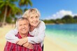 © BillionPhotos.com - Happy family of old couple walking on tropical beach