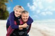 © BillionPhotos.com - Happy family of old couple walking on tropical beach