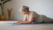 © Debi Kurnia Putra - Mature woman practicing yoga for wellness at home