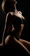 © Cliff - Shadow and silhouette of sexy woman body relaxing in erotic, sexy and seductive lingerie on dark black background. Sexuality, creativity and body of aesthetic model girl with creative beauty. Close-up