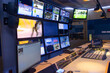© milkovasa - Interior view of a fully equipped broadcast studio with multiple screens and control consoles.