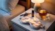 © Cahya - A serene sleep hygiene scene: a bedside table set for a calming wind-down routine with a silk eye mask, lavender, essential oil, and herbal tea.
