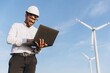 © anatoliycherkas - Arabian engineer working with laptop in a wind turbine power plant