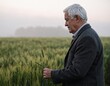 © Parkpoom - The Seasoned Farmer's Field: An experienced farmer inspects a crop, surrounded by a verdant field, capturing the essence of agricultural expertise and dedication.