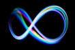 © vetre - Vibrant Infinity Loop. A colorful neon infinity loop glows against a black background
