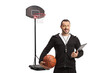 © Ljupco Smokovski - Basketball coach holding a ball and a clipboard
