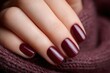© Artinun - Professional female hand model displaying perfect nail manicure featuring deep burgundy polish and French manicure design showcasing beauty salon treatment luxury cosmetics and elegant nail care.