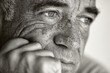 © Ifti Digital - Closeup portrait of senior man reflecting on life moments with a thoughtful expression in a softly lit space during the afternoon