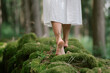 © Thilo Wagner - Natural close-up of female feet walking barefoot on mossy ground in a quiet forest atmosphere