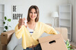 © Pixel-Shot - Young woman with keys to rented apartment and box on moving day