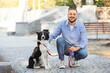 © Pixel-Shot - Young man with Border Collie dog on street