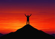 © denijulianto - Silhouette of a person standing on a mountain peak with arms raised against a vibrant sunset sky.