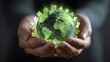 © irawan - Human hands gently cradle a glowing green representation of the world surrounded by sustainability icons