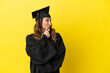 © luismolinero - Middle aged university graduate isolated on yellow background looking to the side