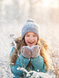 © Tatyana Gladskih - Child walking at winter park. Kid enjoys the snow and the beautiful weather. Happy girl play with snow