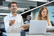 © ty - Happy young male customer support executive working in office.