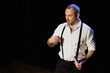 © Dmytro Hai - Actor playing role of offended man and holding scenario on stage