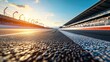 © backup_studio - Empty formula 1 asphalt race track at sunset with grandstand and warm sky. Concept of speed, automotive sport, new beginning.