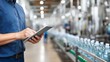 © Elena - Caucasian man manager using digital tablet to monitor production line. Factory worker supervises quality control on bottling conveyor. Industrial technology.