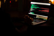 © KseniaJoyg - Programmer's hands are coding on a laptop in the dark with a view of the lights of the night city. The concept of a developer or hacker.