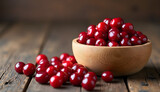 Fresh cherries in a wooden bowl on a rustic wooden table