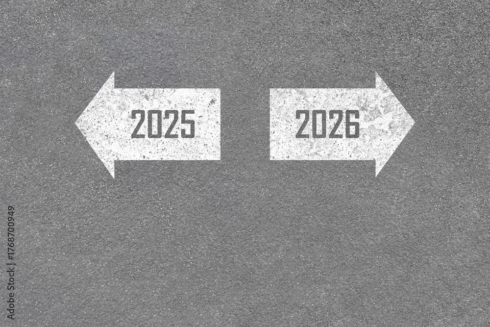 year transition 2025 to 2026 with white arrow paint on asphalt road ...